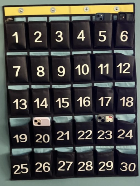 A cellphone caddy hangs from the wall of a classroom on the Winnetka Campus